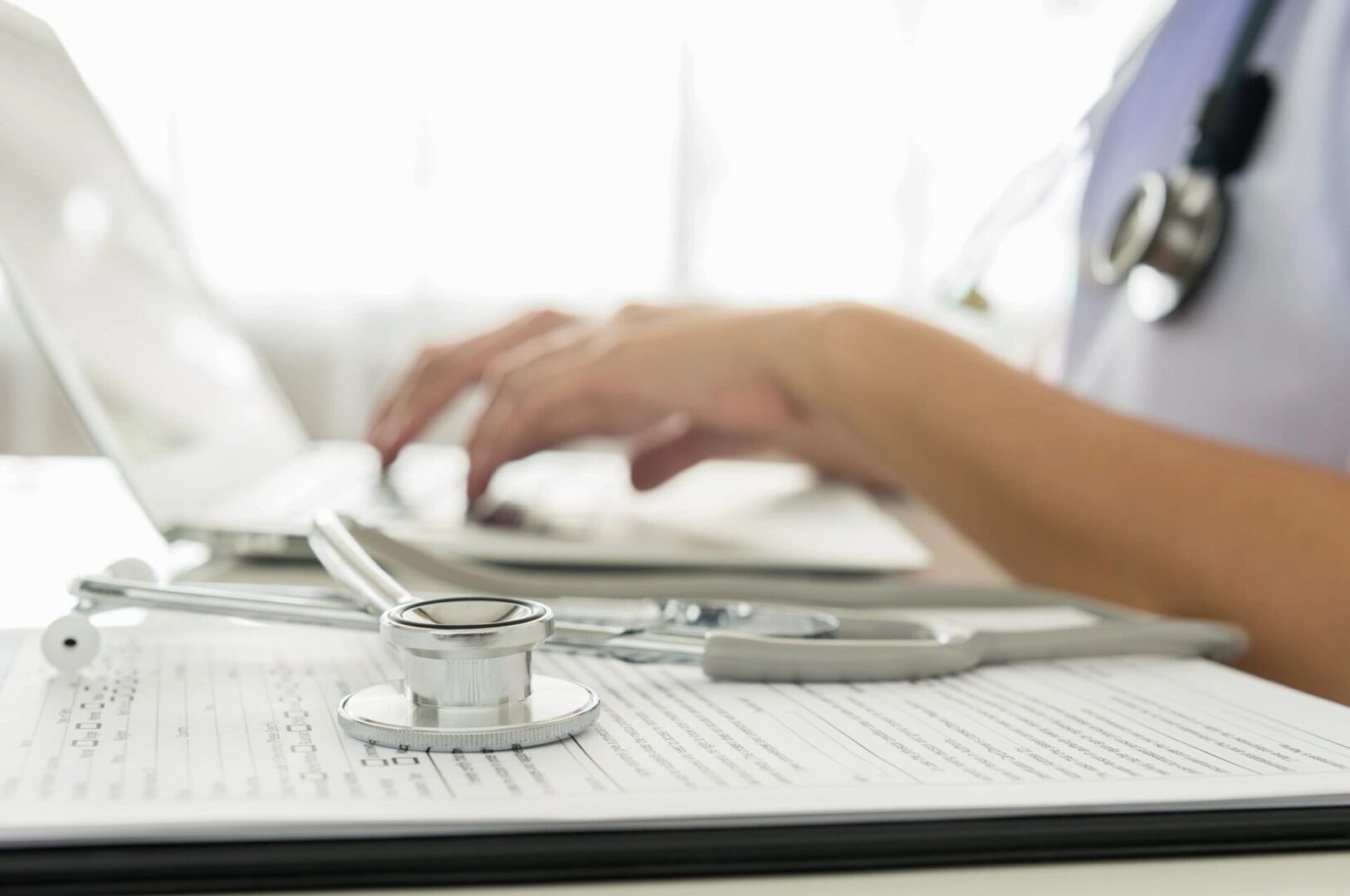 Stethoscope and laptop representing medical coding services
